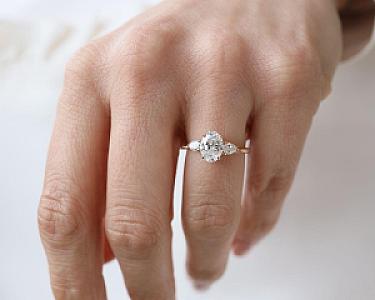 Oval Lab Grown Diamond Engagement Ring: Three Stone Pear Side Stones, Hammered Band - Image 1